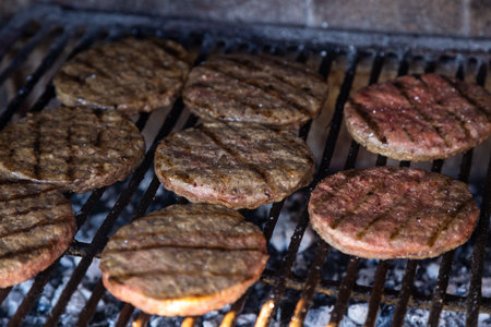 Real Burgers grilling on the barbecue.の写真素材