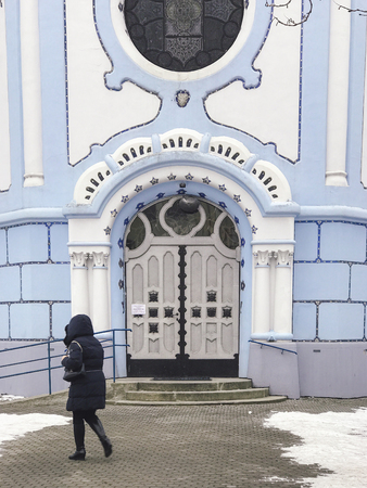 Bratislava, Slovakia - January 28, 2017: Woman walking in front of The Little Blue Church in Bratislava, Slovakiaのeditorial素材