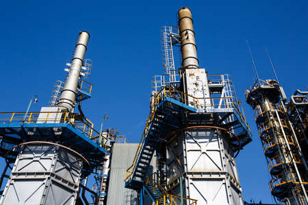 red-white lifting cranes and buildings on the territory of the plantの写真素材