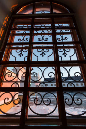 Wrought iron window grille on an old houseの写真素材