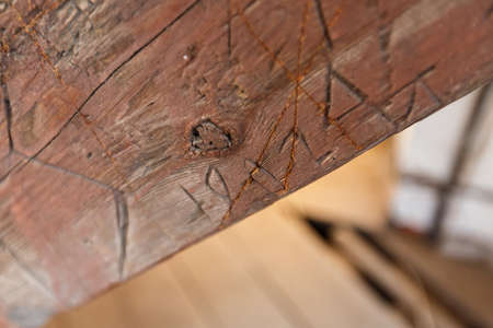 Old wooden fence with words engraving. wood palisade background. planks textureの写真素材