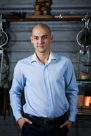 Confident,handsome bussinesman wear stylish  suit  looks with attitude at the camera and button up cufflinks.Horizontal view on gray wall background.の写真素材