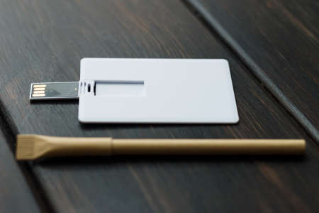 Photo of blank stationery set on wood background. Envelope, business cards, pen usb flash card. Corporate identity template. Responsive design mockup.の写真素材
