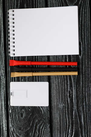 Corporate branding mockup template, isolated on dark wooden background.の写真素材