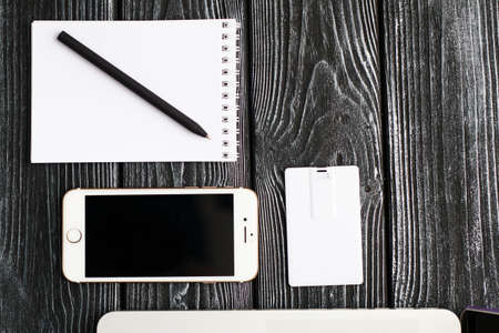 Photo of blank stationery set on wood background. Envelope, business cards, pencil, and A4 paper....