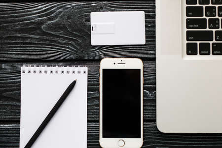 Photo of blank stationery set on wood background. Envelope, business cards, pencil, and A4 paper. Corporate identity template. Responsive design mockup.の写真素材