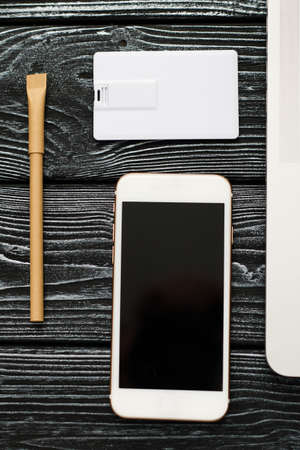 Photo of blank stationery set on wood background. Envelope, business cards, pencil, and A4 paper....