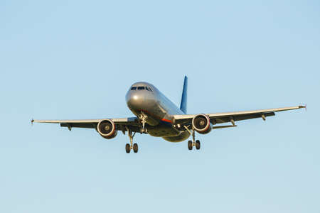 Passenger plane on final approach, with landing lights in viewの写真素材