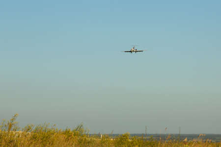 Large passenger plane flying in the blue skyの写真素材