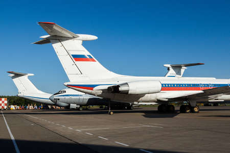 Commercial airplane parking at the airport.White airplane parked to terminal in airport.Modern white twin ehgine civil large wide body airplane taxiing for take off at International airport.の写真素材