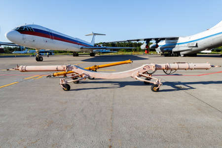 Commercial airplane parking at the airport.White airplane parked to terminal in airport.Modern white...