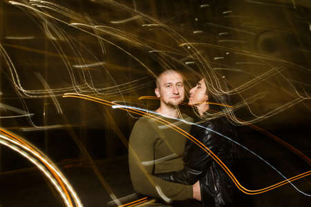 young stylish modern couple of young beautiful women wiht long dark hair and handsome man are...