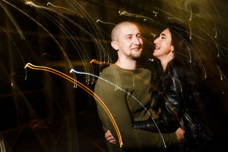 young stylish modern couple of young beautiful women wiht long dark hair and handsome man are...