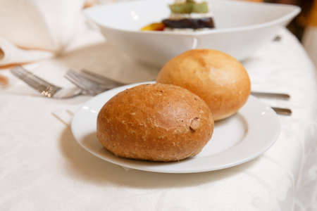 Table setting for an event party or wedding reception.A beautiful banquet table with snacks and bouquet on the tableの写真素材