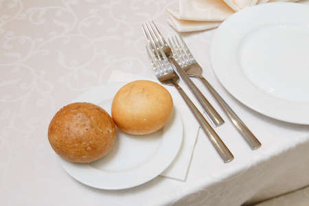 Table setting for an event party or wedding reception.A beautiful banquet table with snacks and bouquet on the tableの写真素材