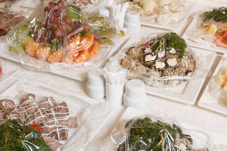 Table setting for an event party or wedding reception.A beautiful banquet table with snacks and bouquet on the tableの写真素材