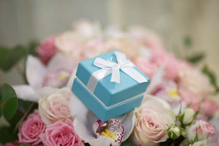 a festive bouquet of pink roses with a box for an engagement ring. giftの写真素材