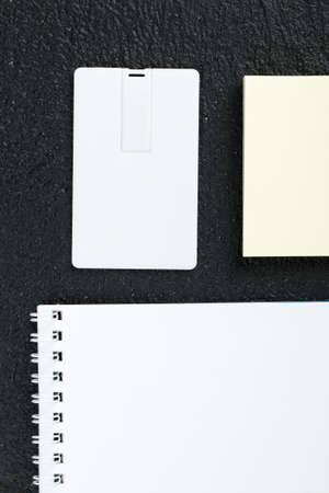 Workspace with envelope, wallet, business card, notebook, pencil, badge. Office desk wooden background top view mock upの写真素材