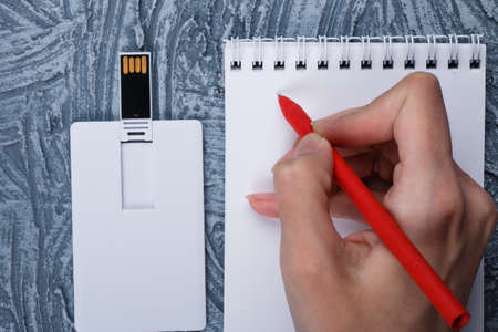 Business card blank, notepad, mobile phone, vallet, smart watch, notebook, mini food basket and pen at office desk table top view. Corporate stationery branding mock-upの写真素材