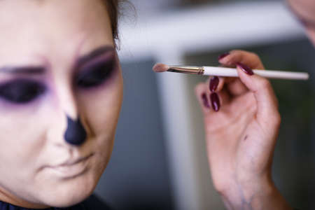 Backstage scene: Professional Make-up artist doing glamour model makeup at workの写真素材