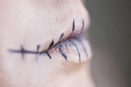 Close-up of a girl with a terrible terrible makeup for Halloween in the form of a corpse or skeletonの写真素材