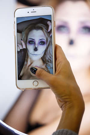 close up of a face of a girl with creative visage.Portrait of the bright beautiful girl with art colorful make-up. Halloweenの写真素材