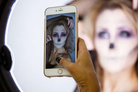 close up of a face of a girl with creative visage.Portrait of the bright beautiful girl with art colorful make-up. Halloweenの写真素材
