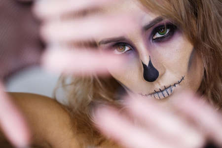 Close up of beautiful female eye with makeup. halloween. skeletonの写真素材
