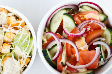 top view of two salads greeck salad and cesar salad isolated on white background. photo for menu