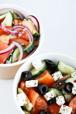 top view of two salads greeck salad and cesar salad isolated on white background. photo for menuの写真素材