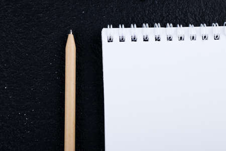beige Penc and notebook isolated on dark black background : concept of creative , idea, concept,...