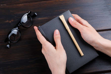 hand holding beige pen pencil with mock up design. office style work spaceの写真素材