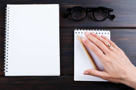 hand holding beige pen pencil with mock up design. office style work spaceの写真素材