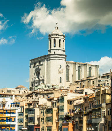 View of Girona Cathedral with its colorful river houses in a great sunny day. Costa Brava.の写真素材