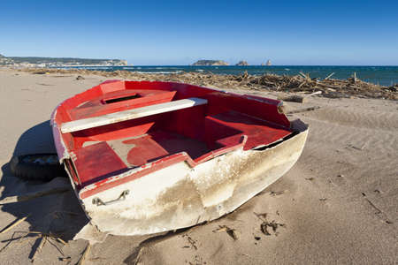 View of this red wreck boat in this lonliness beach.の写真素材