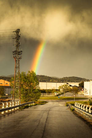 View of rainbow after big spring storm in small industrial village.の写真素材