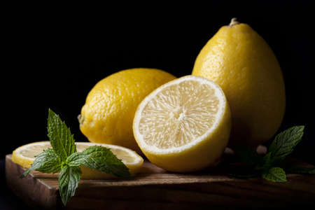 Fresh lemons with a fine art look on a black background.の写真素材