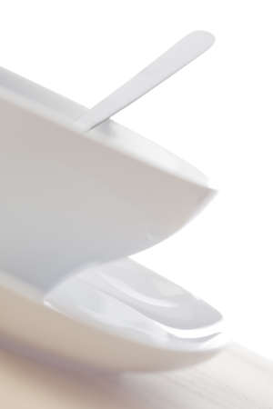 Clean soup bowl on a white dish with a minimal composition.の写真素材
