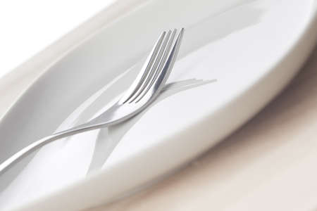Perfect fork on a white clean dish.の写真素材