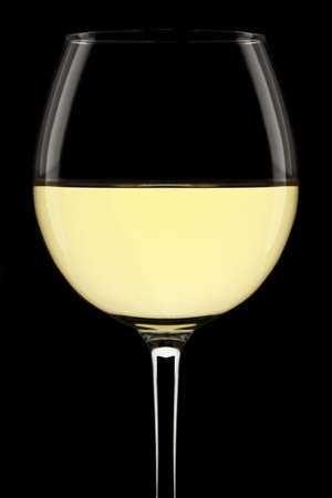 White wine glass isolated on a black background.の写真素材