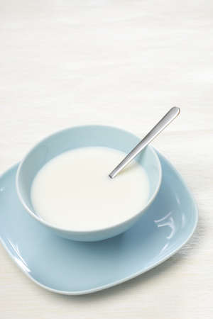 Breakfast milk in a blue bowl whit a copy space for your text.の写真素材