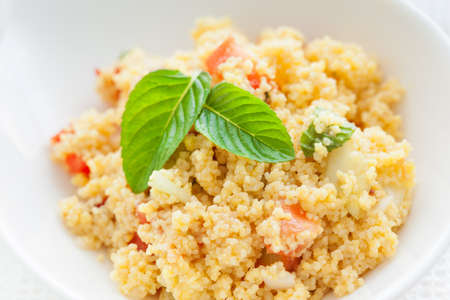 Fresh Tabbouleh with couscous, mint, tomato on a white dish.の写真素材