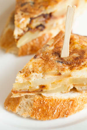 Portion of a spanish potato omelet called "tortilla de patatas" typical spanish pub food.の写真素材