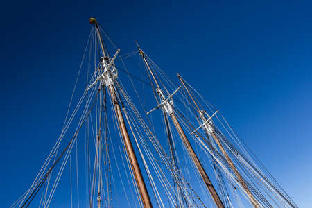 Three masts of very old sail.