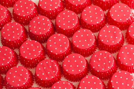 Bunch of red and white cupcake liners making a background