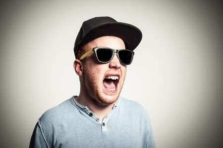 Young redhead is screaming very loud.