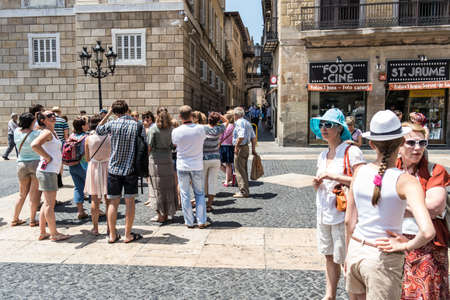 BARCELONA, SPAIN - 2 JULY: Tourists visits Sant Jaume square, where there is the catalan parliament and government. July 2, 2013.のeditorial素材