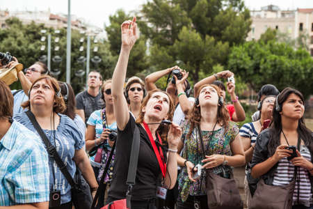 BARCELONA, SPAIN - 19 JUNE: Group of tourists look to La Sagrada Familia, on of the most famous tourism attraction in the City. Barcelona june 19, 2012.のeditorial素材