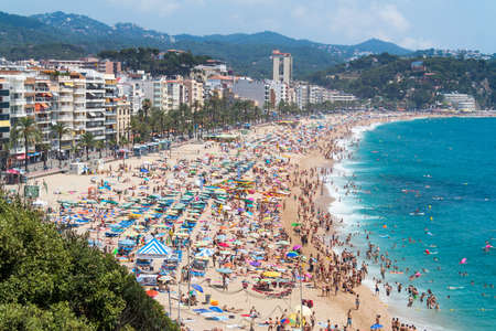 LLORET DE MAR, SPAIN - 28 JULY  Tourists enjoy at the beach in the summertime in Lloret de Mar, the favourite travel destination for the england tourists  Lloret de mar July 28, 2013 のeditorial素材