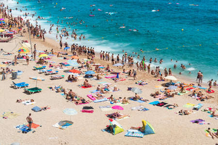 LLORET DE MAR, SPAIN - 28 JULY  Tourists enjoy at the beach in the summertime in Lloret de Mar, the favourite travel destination for the england tourists  Lloret de mar July 28, 2013 のeditorial素材